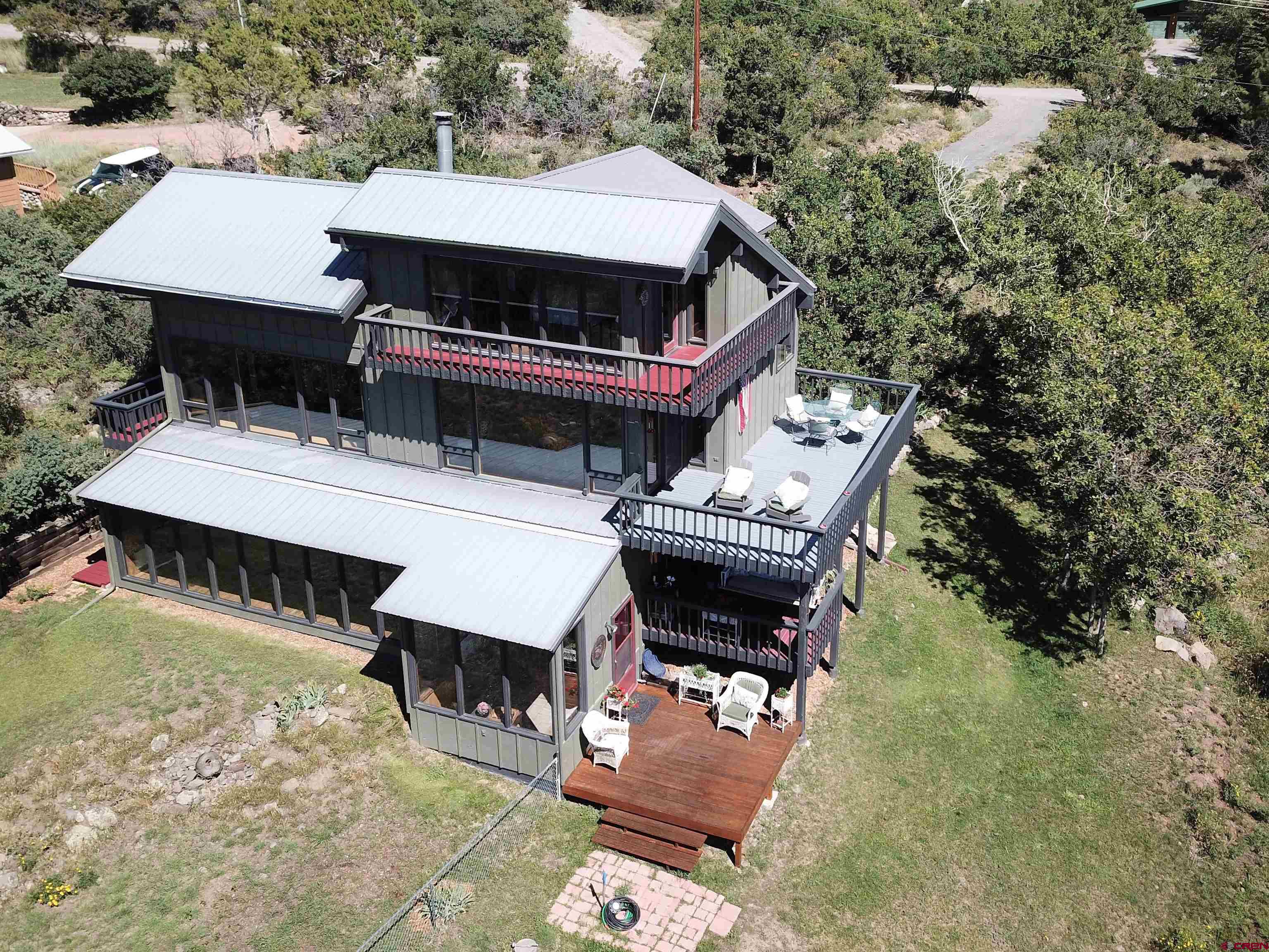 21939-21951 2225 Road Cedaredge, CO 81413 - Photo 3 of 35 an aerial view of a house with swimming pool and outdoor seating