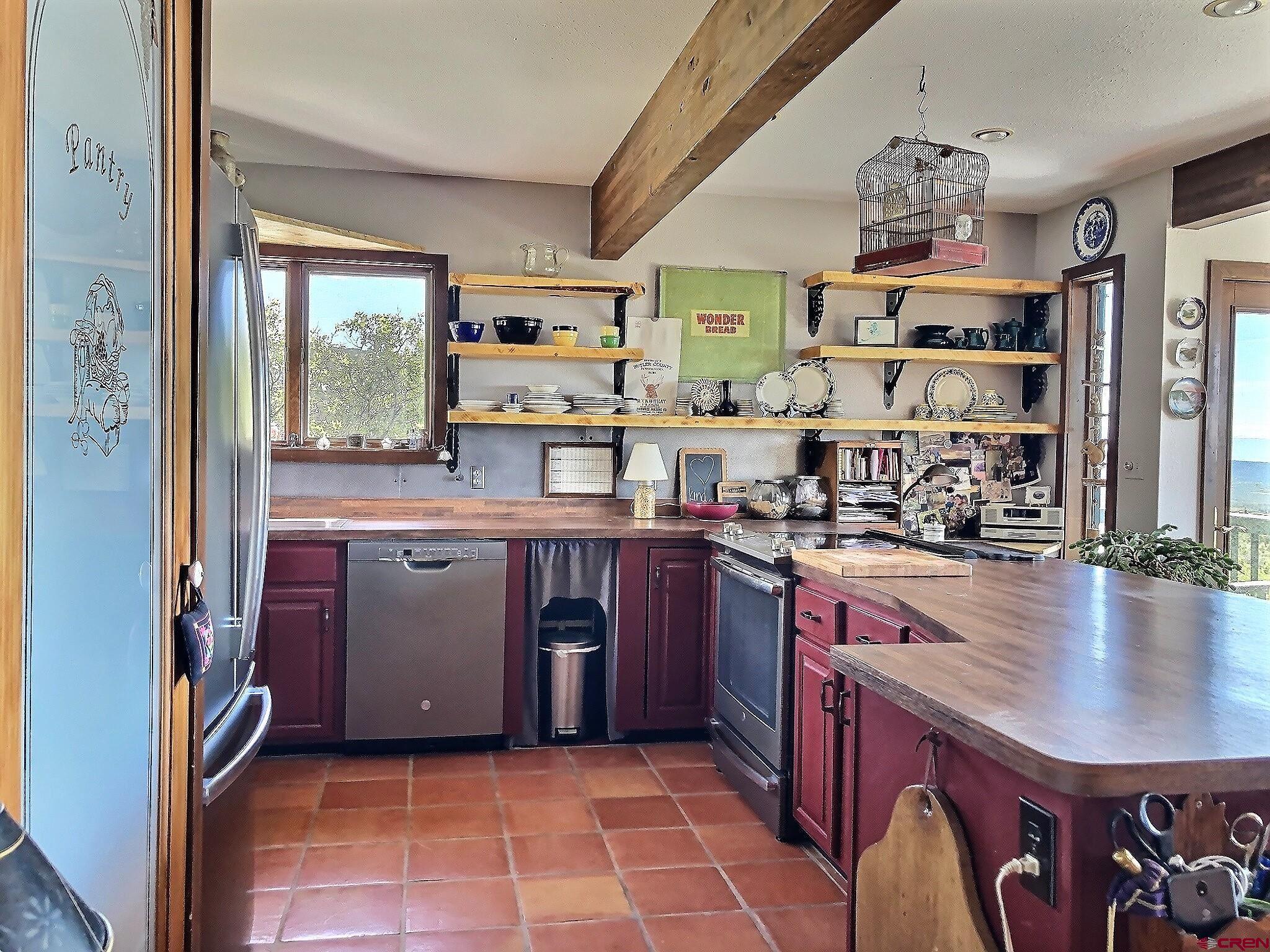 21939-21951 2225 Road Cedaredge, CO 81413 - Photo 8 of 35 a kitchen with stainless steel appliances granite countertop a stove a sink and a refrigerator