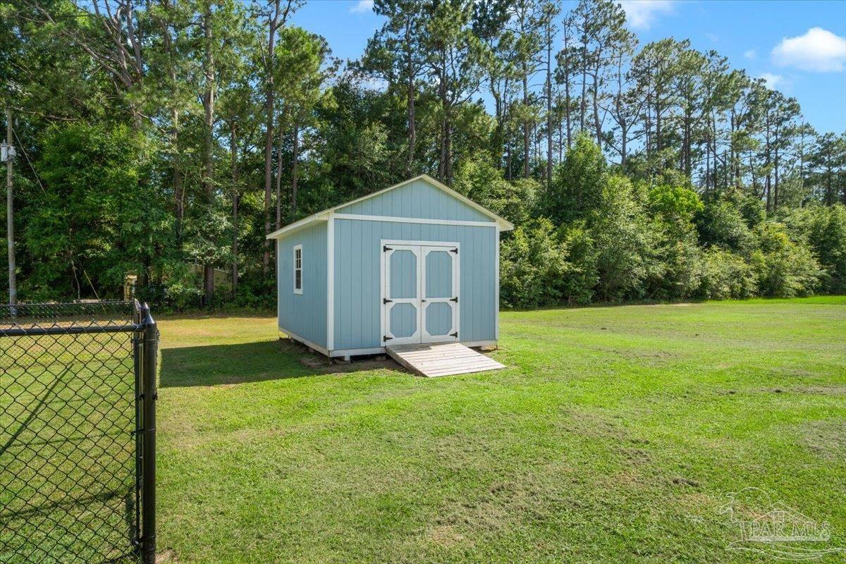 4955 Blue Ribbon Drive Milton, FL 32583 - Photo 28 of 32 a front view of a house with yard and green space