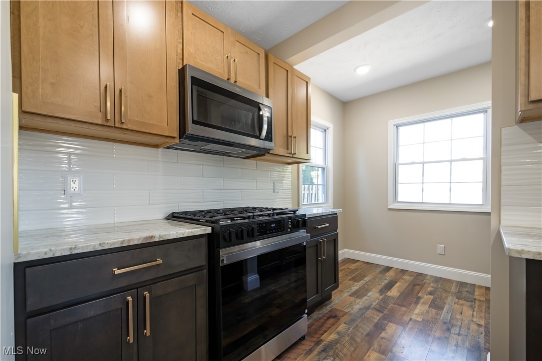 3716 Rolliston Road Cleveland, OH 44120 - Photo 17 of 37 Kitchen with gas stove, tasteful backsplash, stainless steel microwave, light stone counters, and recessed lighting