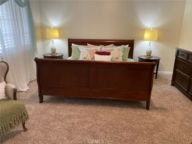 a bedroom with a bed and a lamp