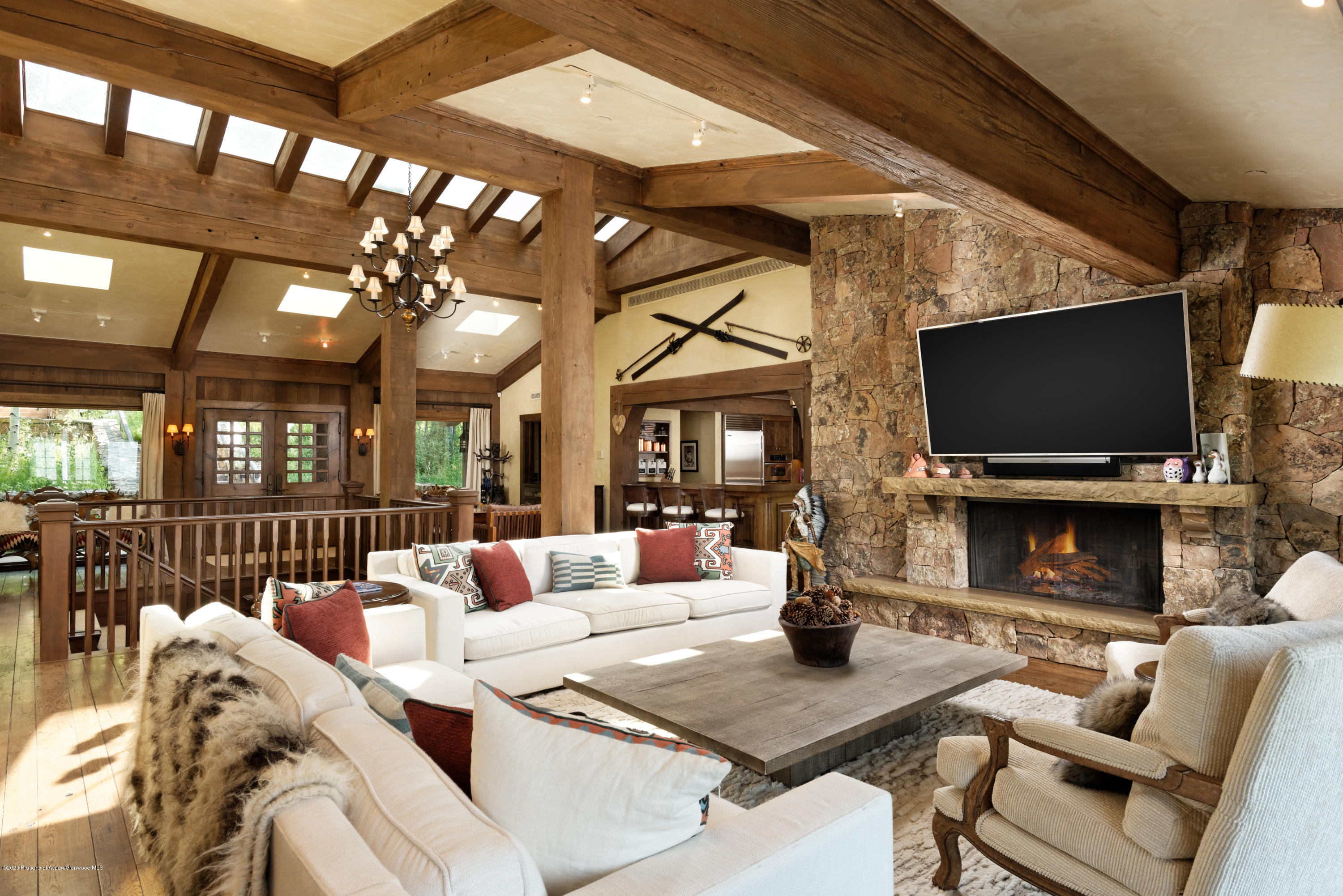 a living room with furniture a flat screen tv and a large window