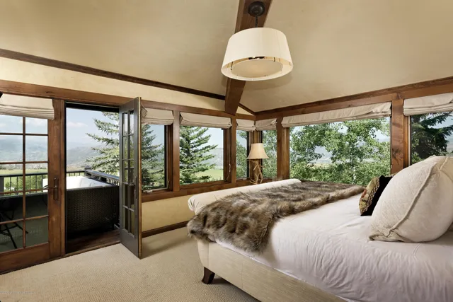 a bedroom with a bed and flat screen tv