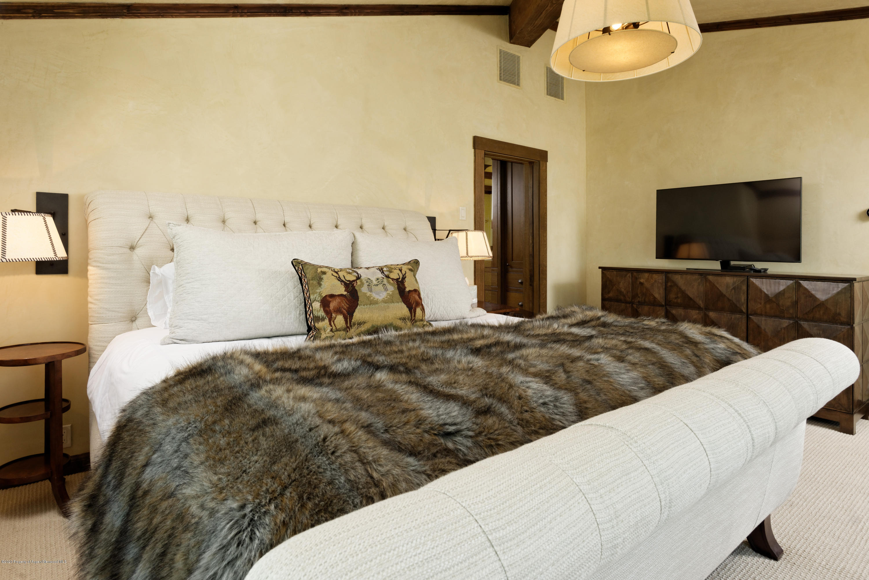 565 North Starwood Road Aspen, CO 81612 - Photo 12 of 50 a bedroom with a bed and flat screen tv