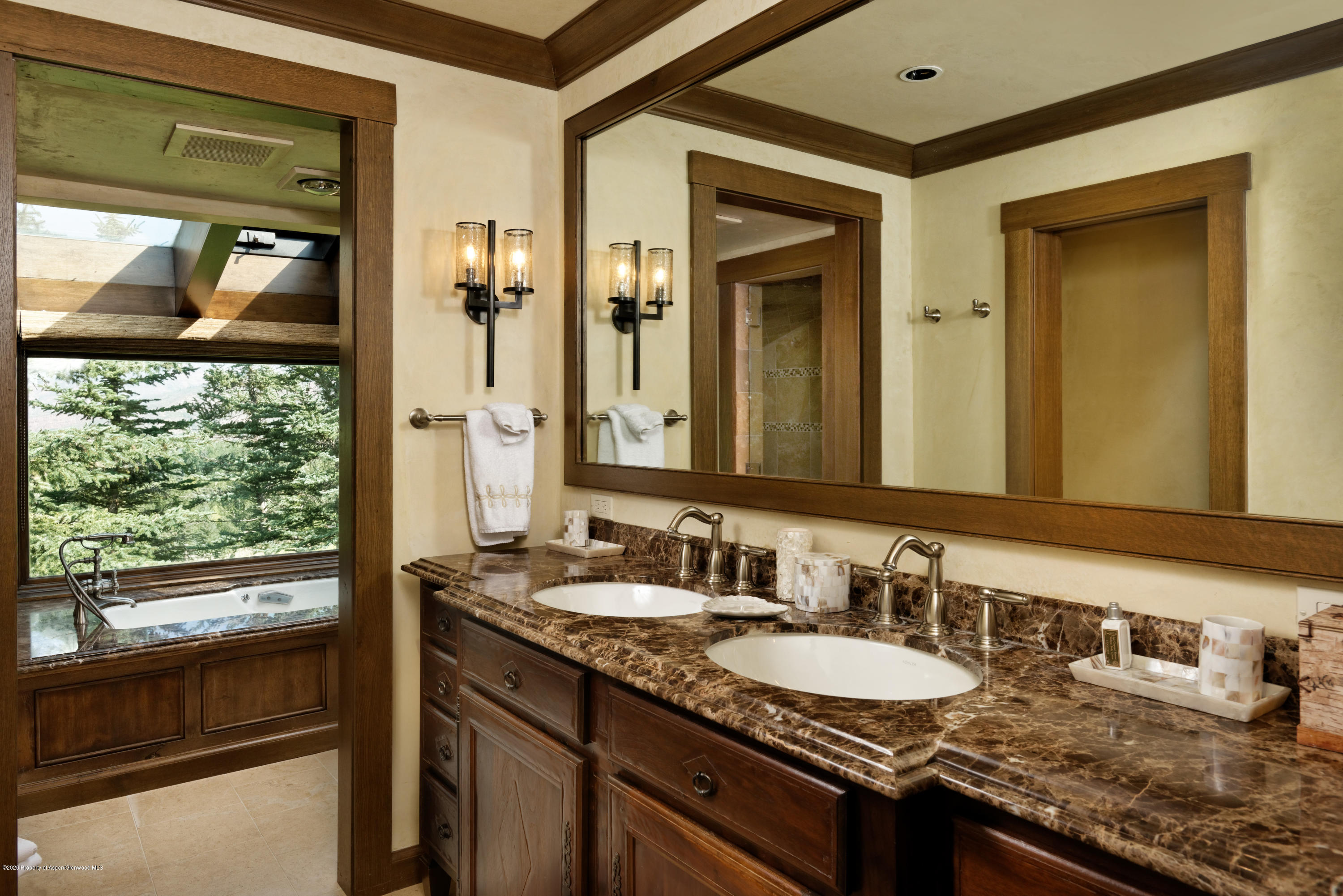 565 North Starwood Road Aspen, CO 81612 - Photo 13 of 50 a bathroom with a granite countertop sink and a mirror