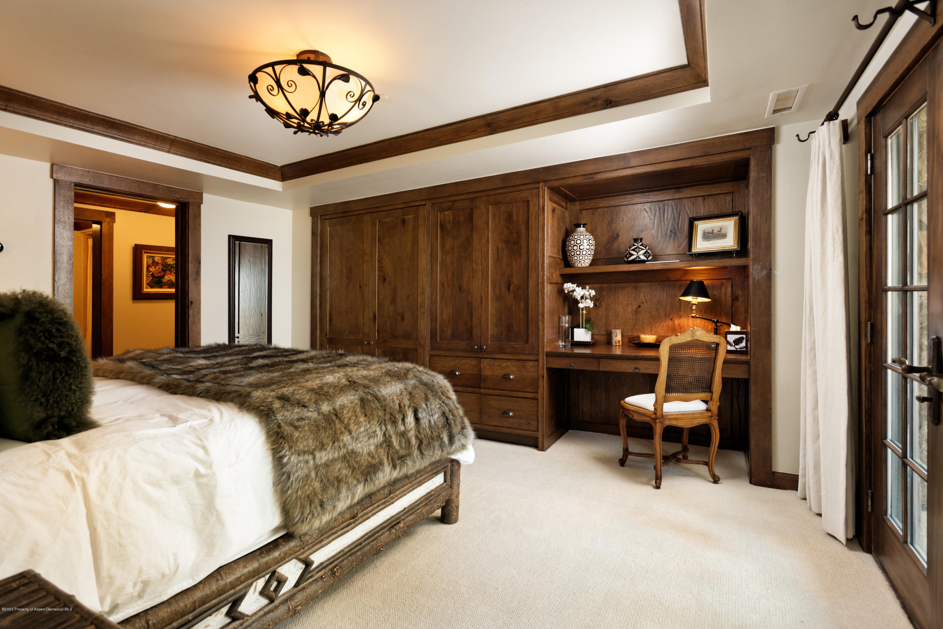 565 North Starwood Road Aspen, CO 81612 - Photo 17 of 50 a bedroom with a bed and a chandelier