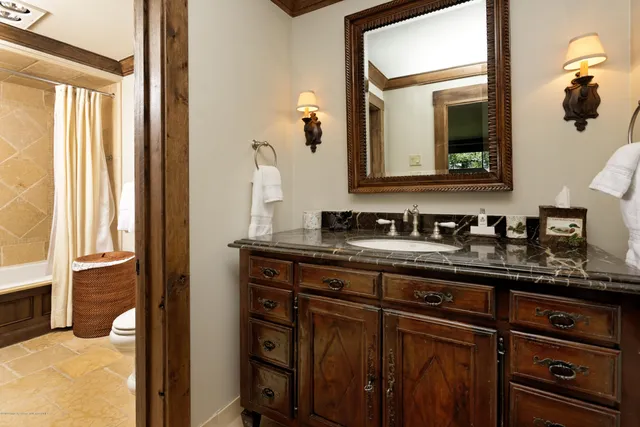 a spacious bedroom with a bed and a large window