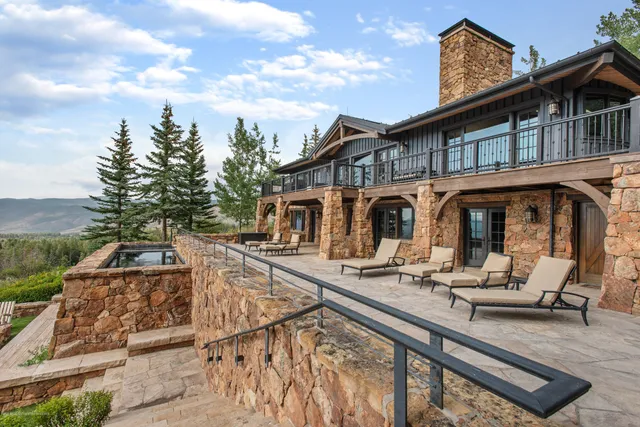 a white house with a yard and sitting area