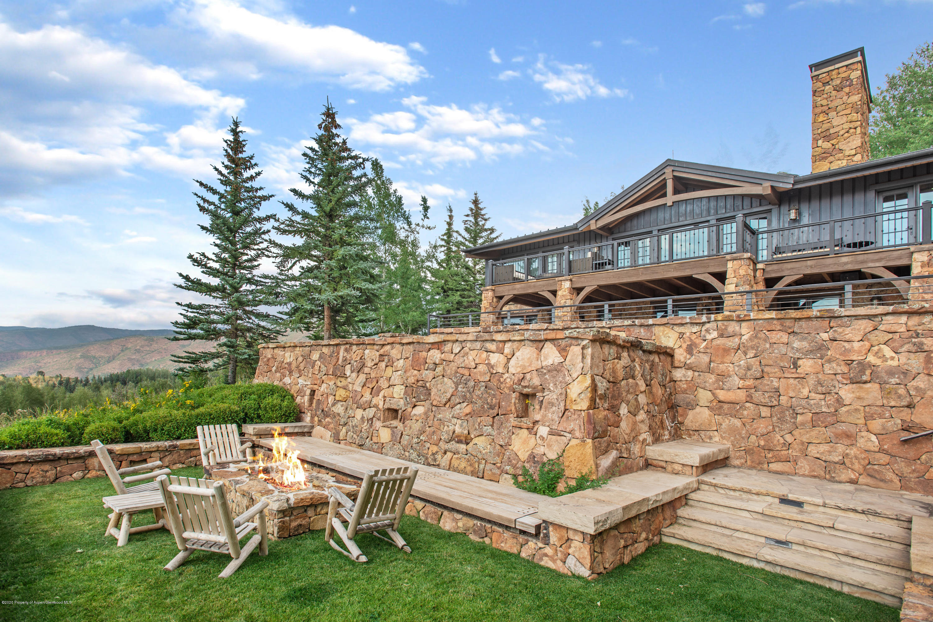 565 North Starwood Road Aspen, CO 81612 - Photo 33 of 50 a white house with a yard and sitting area