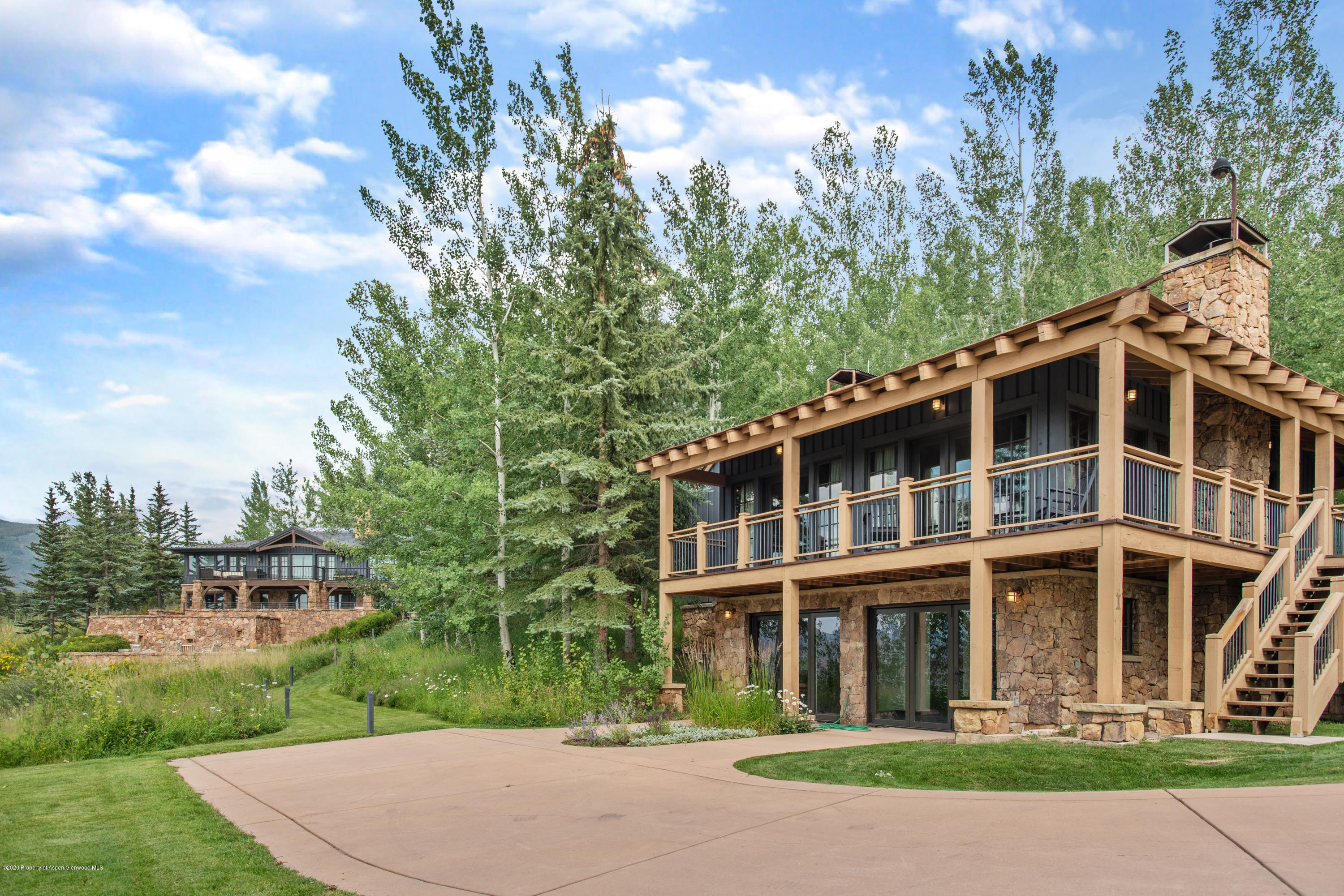 565 North Starwood Road Aspen, CO 81612 - Photo 34 of 50 a front view of a house with a yard