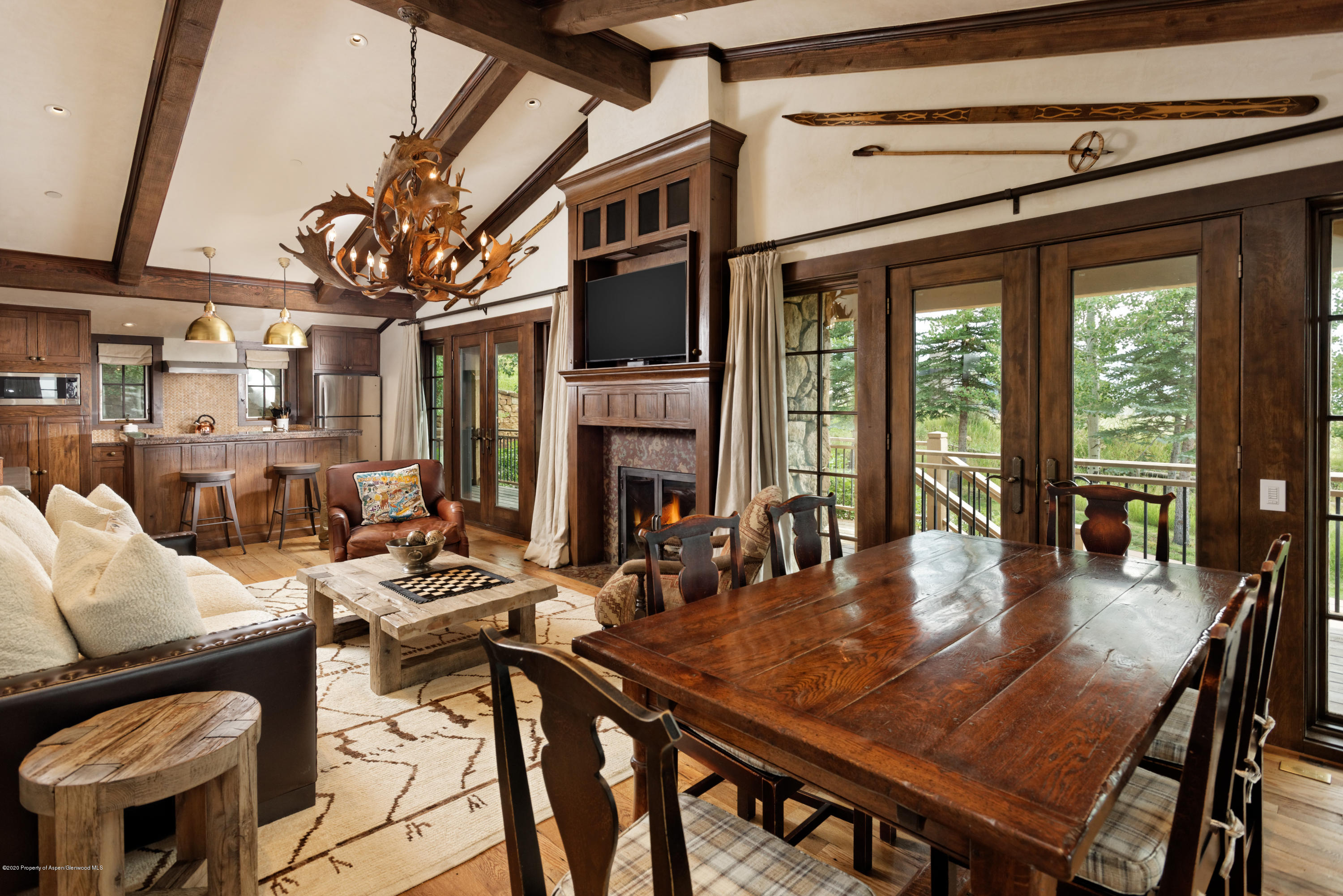 565 North Starwood Road Aspen, CO 81612 - Photo 35 of 50 a dining room with furniture a fireplace and large windows