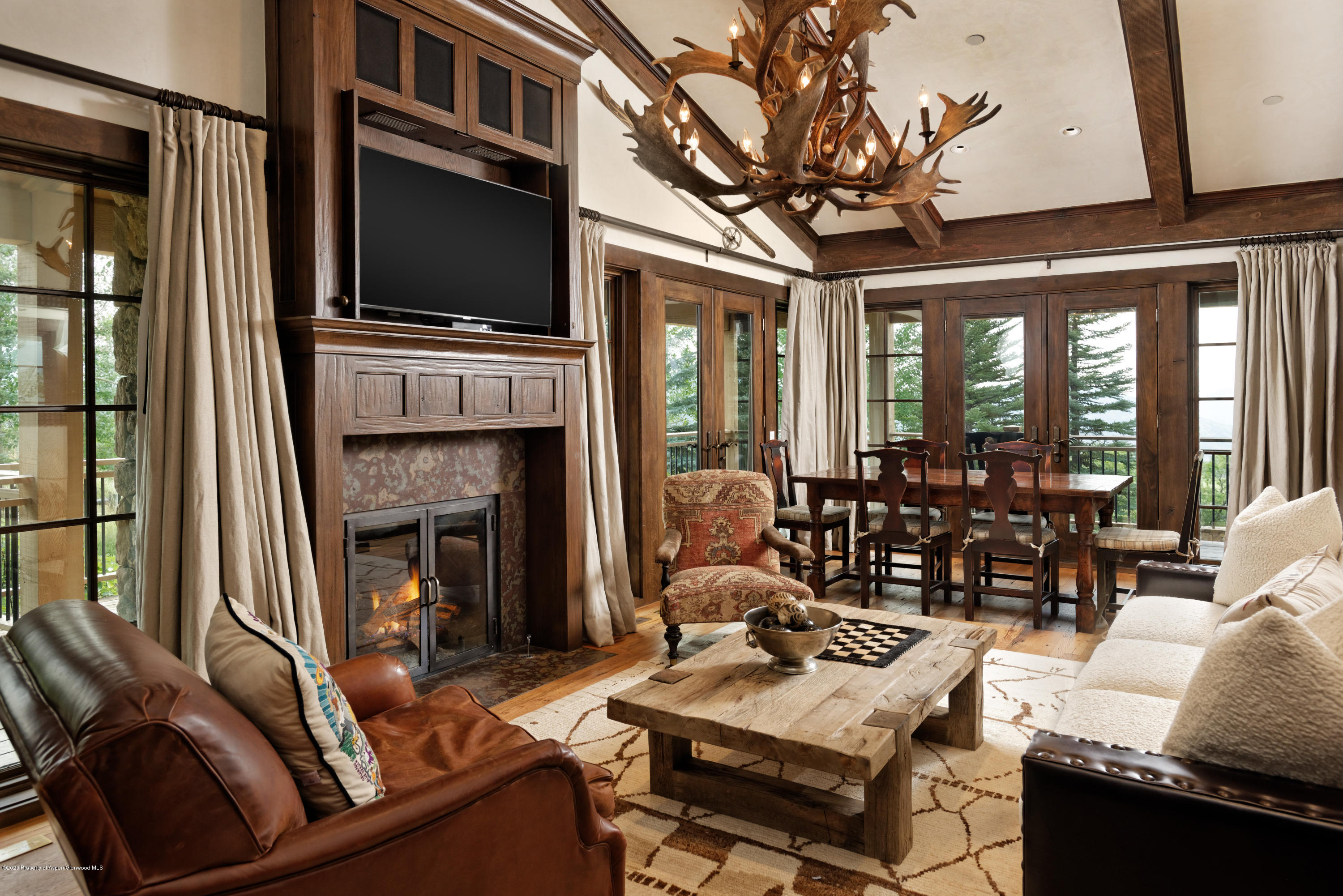 565 North Starwood Road Aspen, CO 81612 - Photo 36 of 50 a living room with fireplace furniture and a flat screen tv