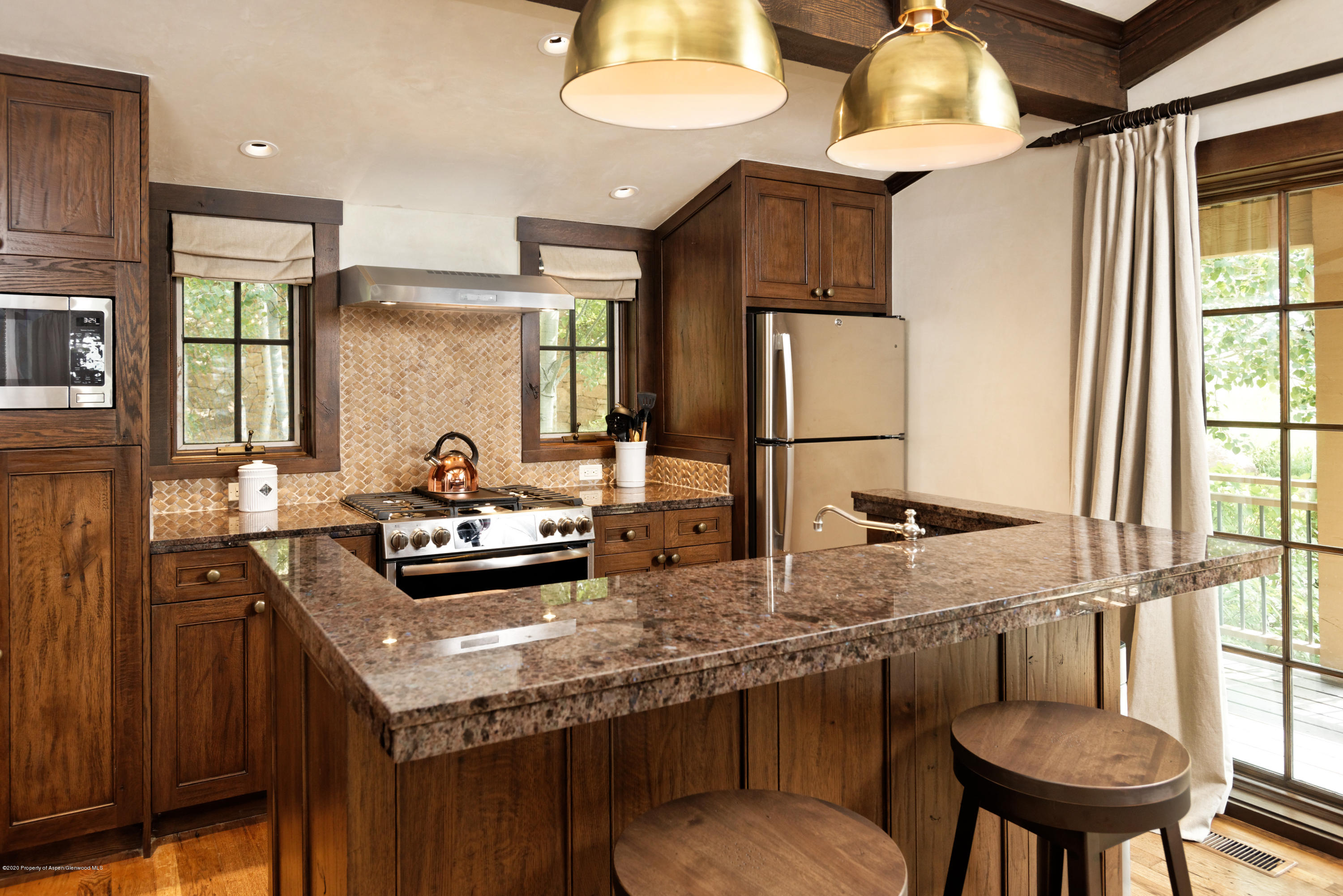 565 North Starwood Road Aspen, CO 81612 - Photo 37 of 50 a kitchen with granite countertop a sink and a stove