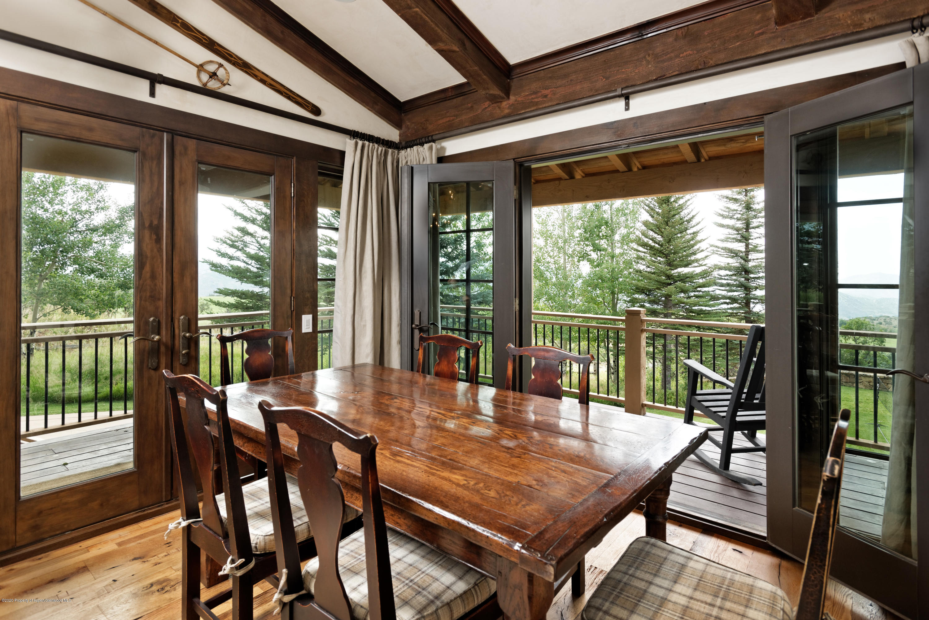 565 North Starwood Road Aspen, CO 81612 - Photo 38 of 50 a dining room with furniture window and wooden floor