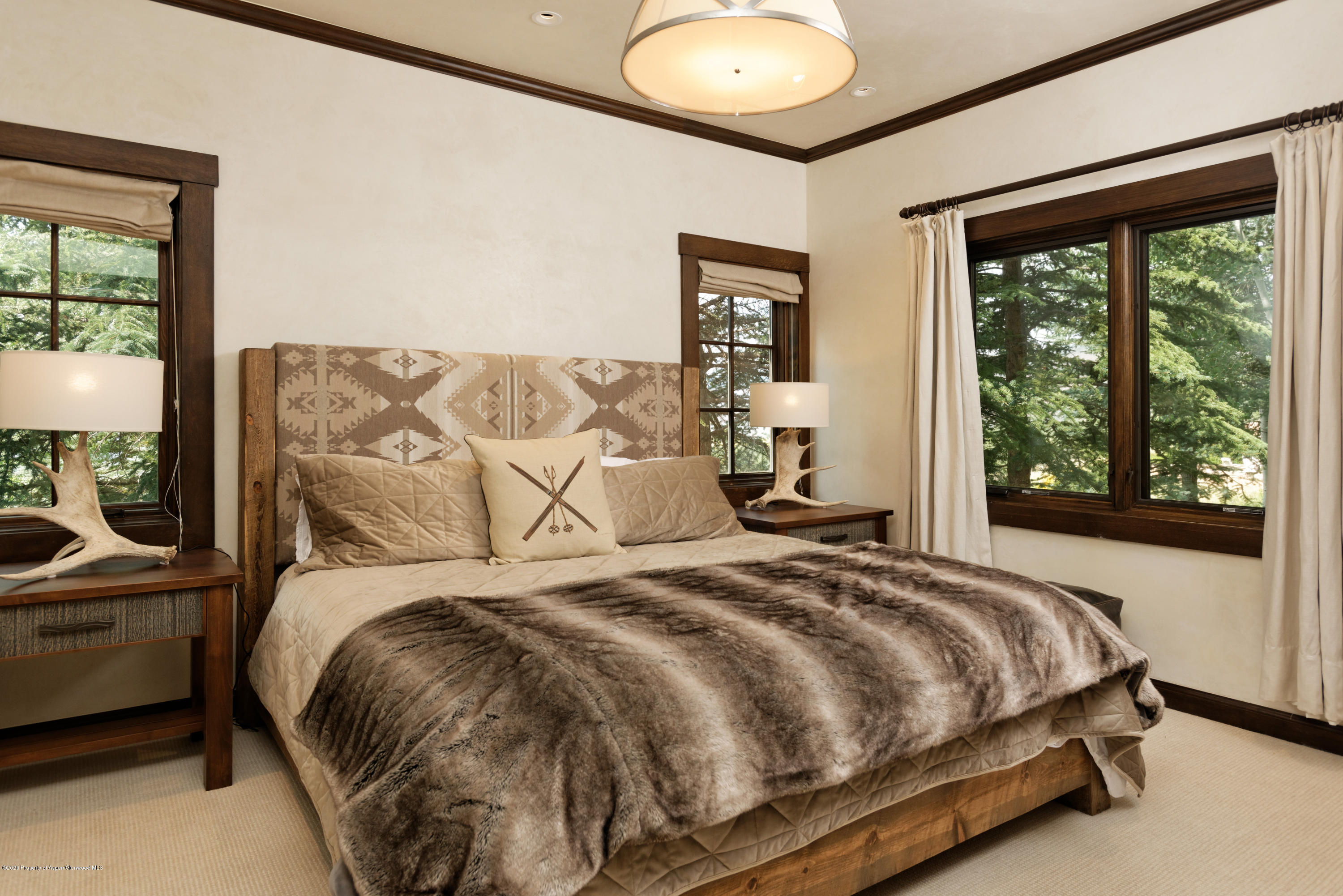 565 North Starwood Road Aspen, CO 81612 - Photo 40 of 50 a bed sitting in a bedroom next to a window