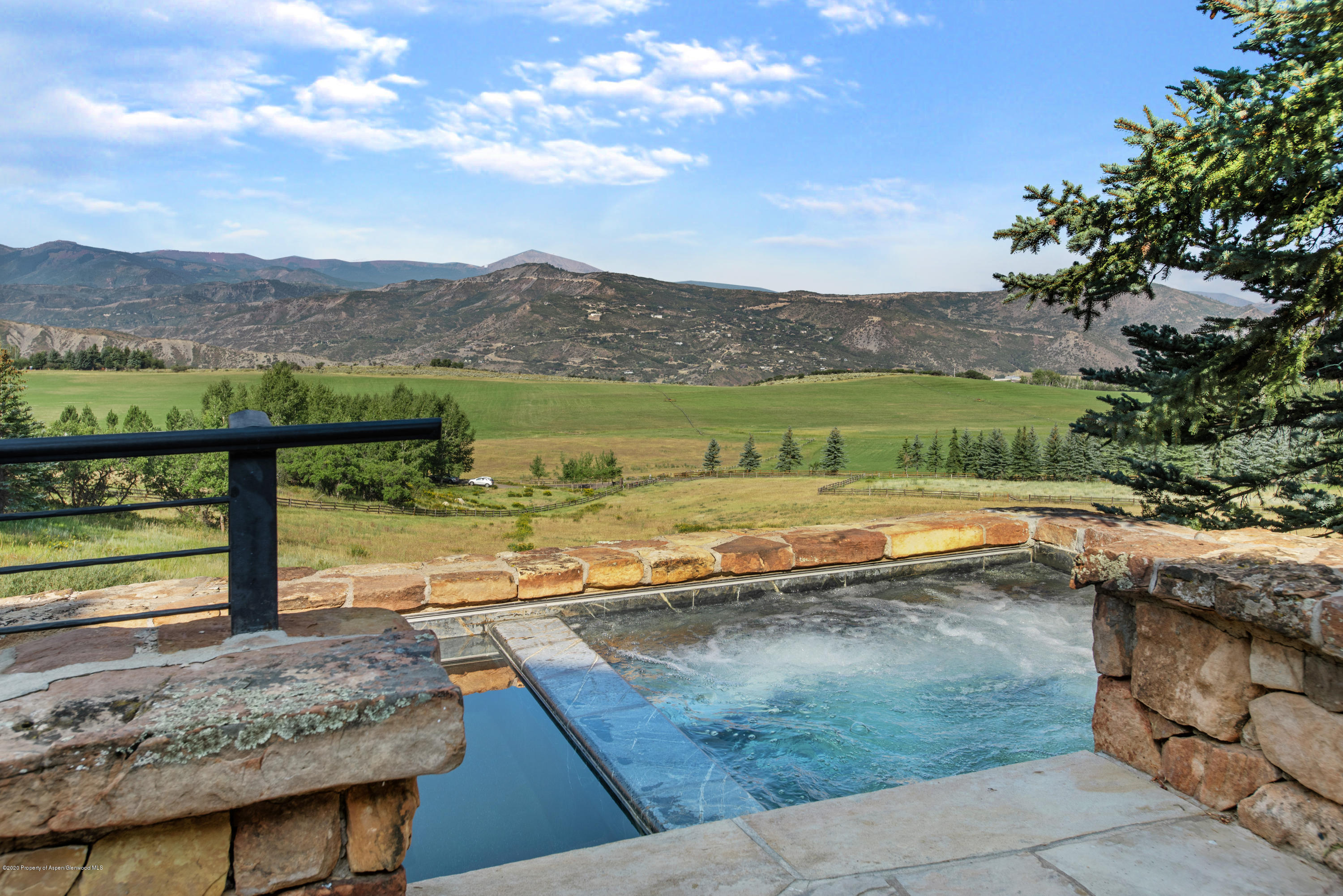 565 North Starwood Road Aspen, CO 81612 - Photo 4 of 50 a view of a lake from a yard