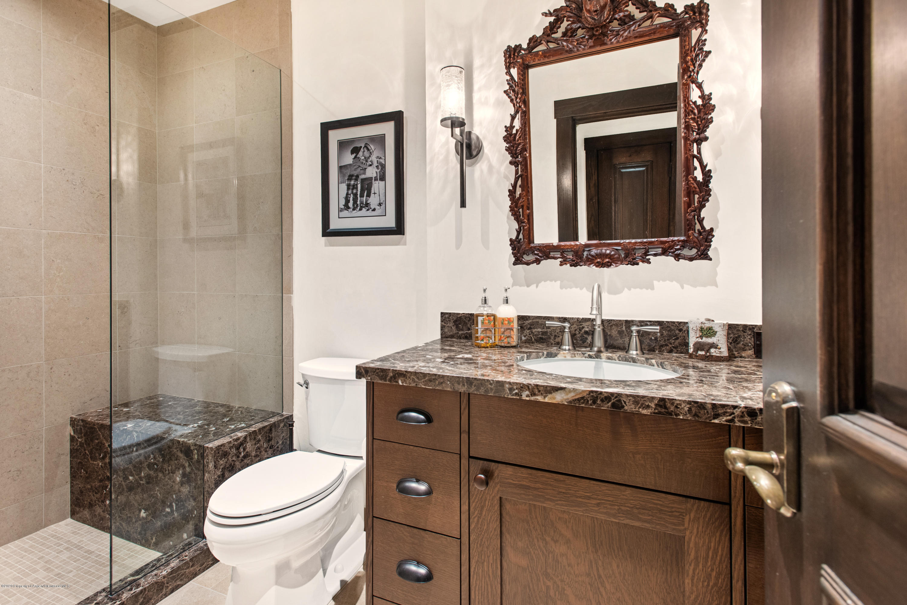 565 North Starwood Road Aspen, CO 81612 - Photo 42 of 50 a bathroom with a granite countertop toilet sink and mirror