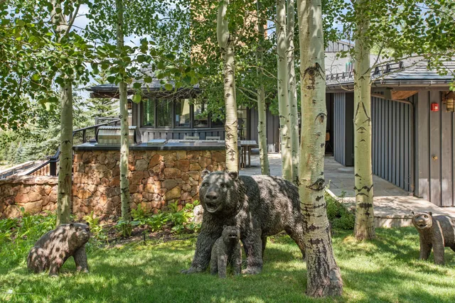 a view of a house with a yard and sitting area
