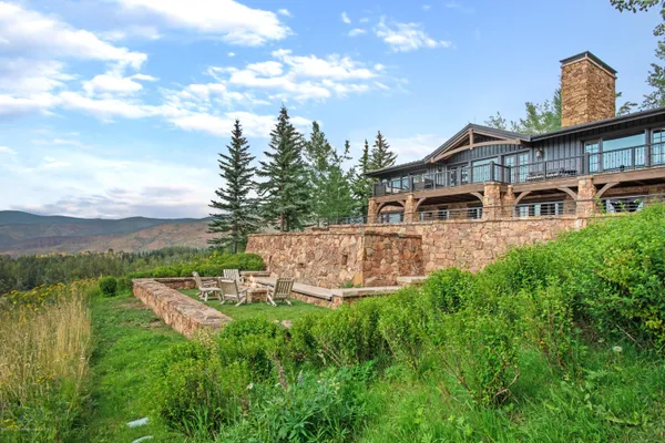 a front view of a house with yard and green space