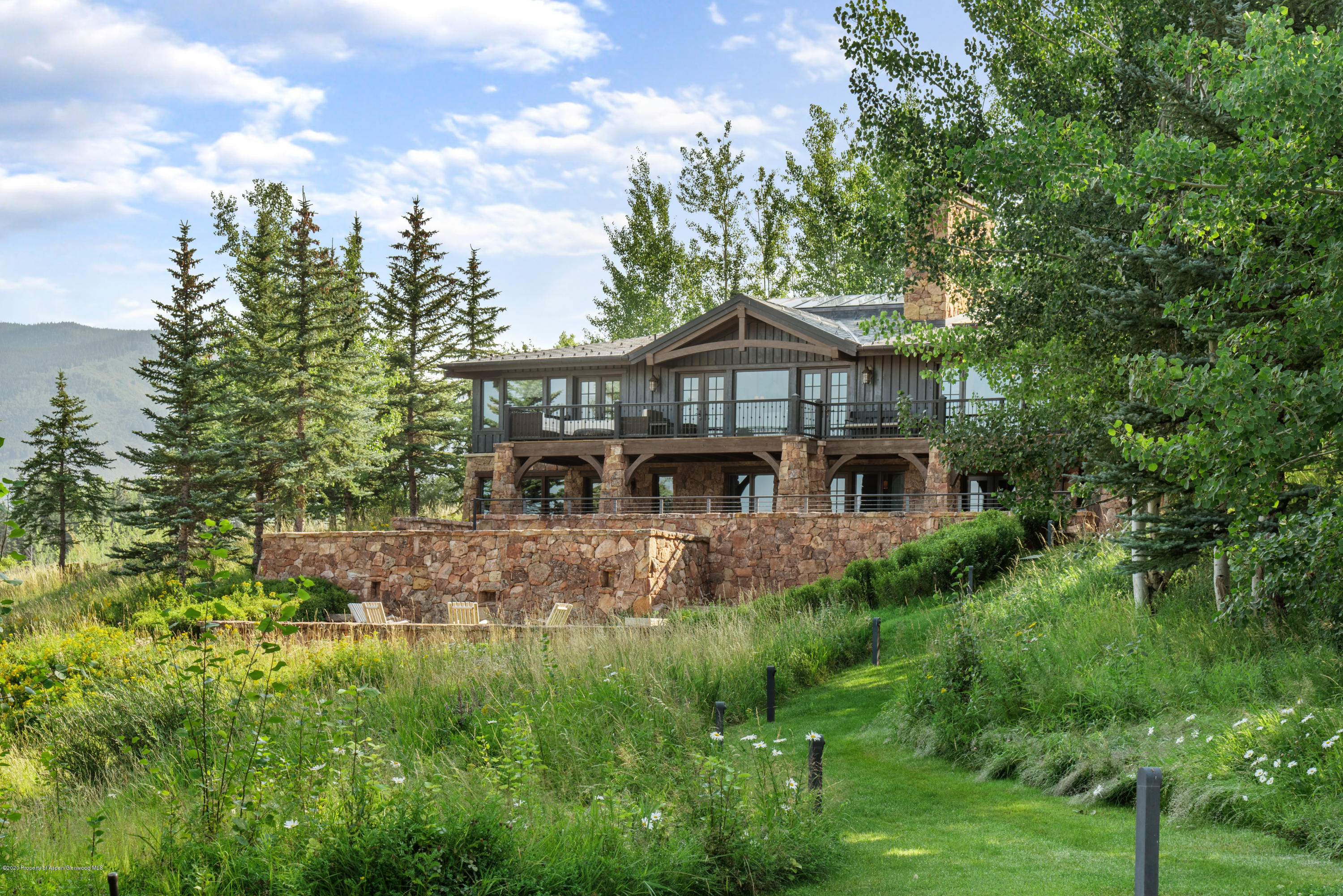 565 North Starwood Road Aspen, CO 81612 - Photo 47 of 50 a front view of a house with yard and green space