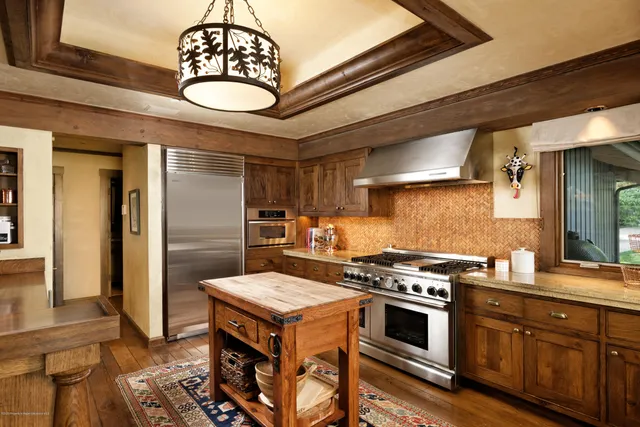a kitchen with a table chairs stove and cabinets