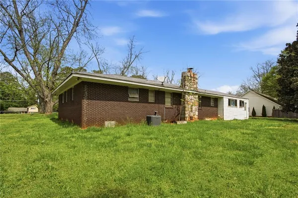 a front view of house with yard and trees