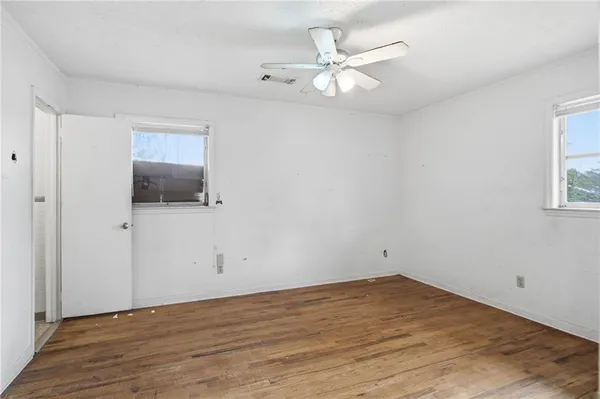 wooden floor in an empty room with a window