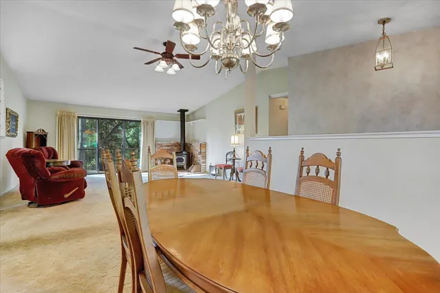 a kitchen with stainless steel appliances kitchen island granite countertop a refrigerator and a stove top oven