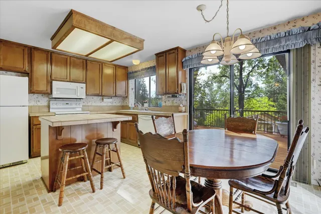 a view of a dining room with furniture and chandelier