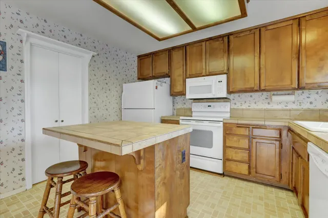 a stove top oven sitting inside of a kitchen
