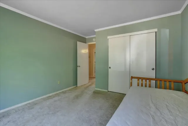 a bedroom with a large bed and a window