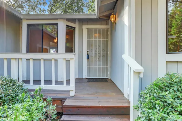 a living room with furniture large windows and flat screen tv