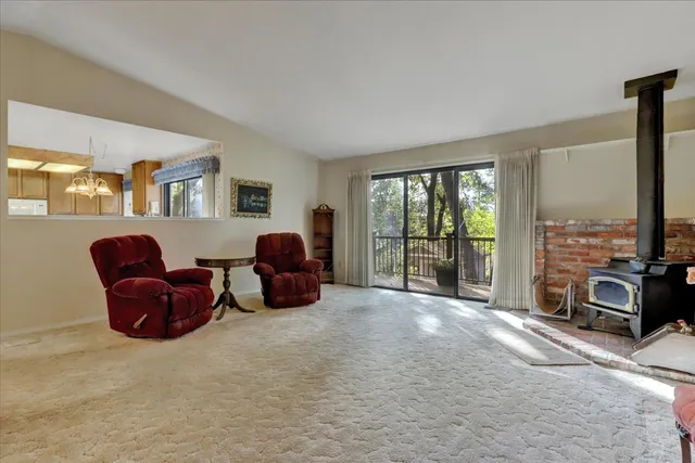 a living room with furniture large window and a flat screen tv