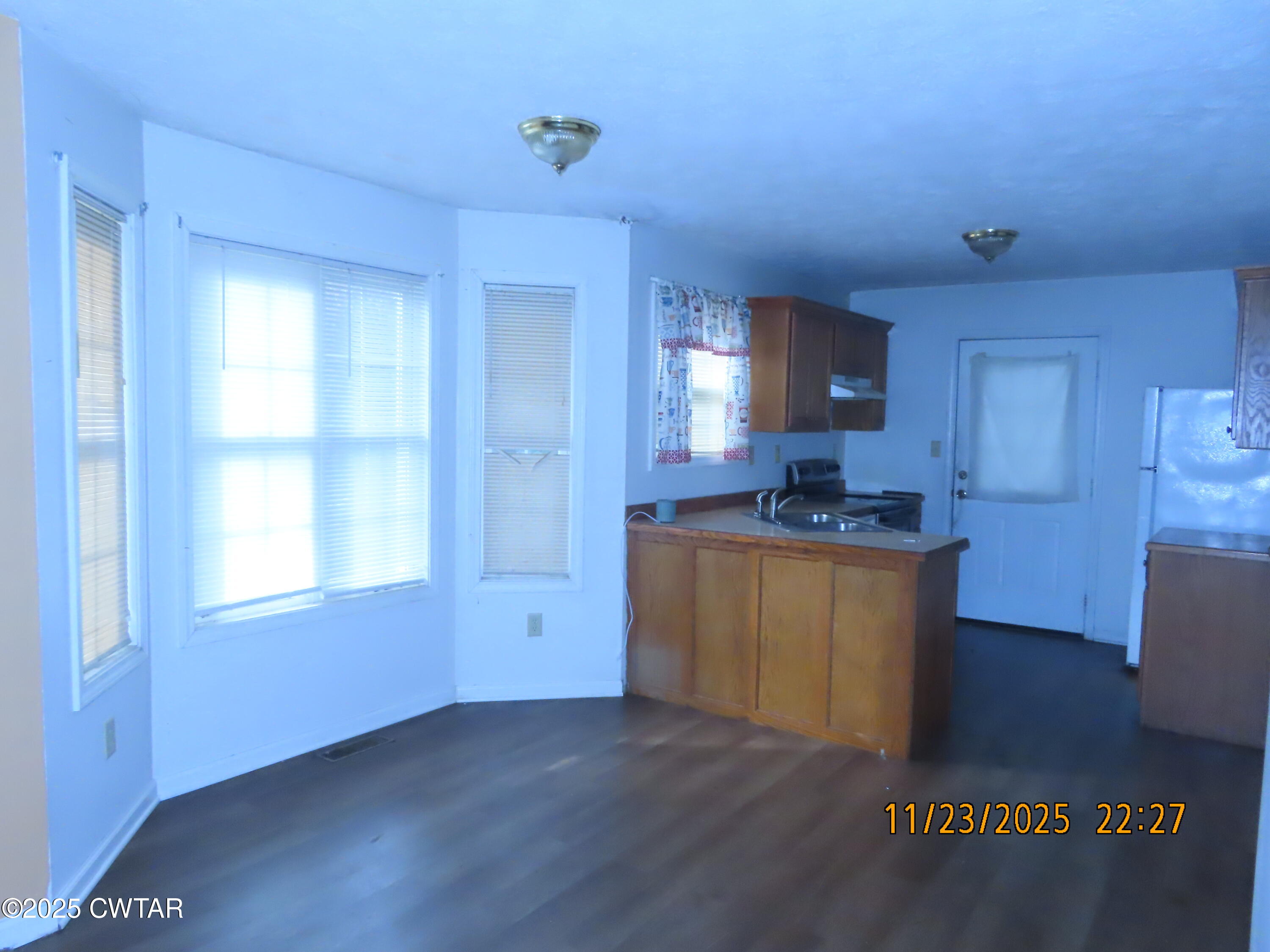 111 Rhea Street Jackson, TN 38301 - Photo 13 of 24 a kitchen with granite countertop a sink cabinets and wooden floor