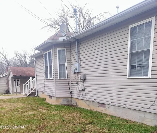 a view of a house with a yard and an outdoor space