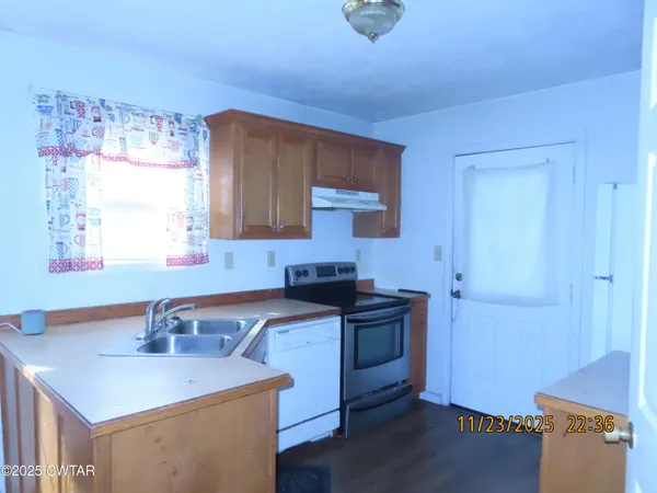 a kitchen with a sink stove and cabinets