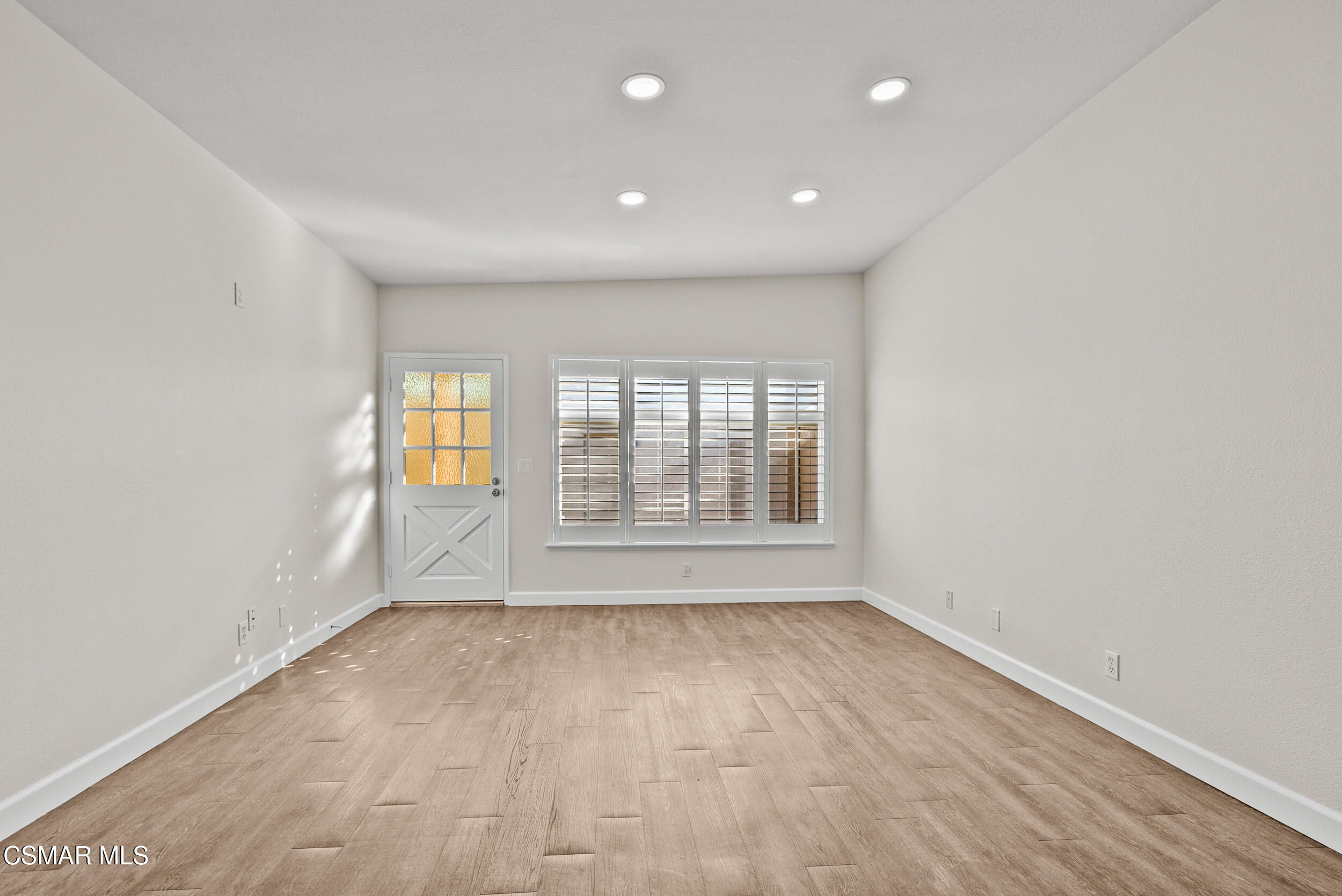 2930 Isle Way, Unit B Oxnard, CA 93035 - Photo 12 of 35 an empty room with wooden floor and windows