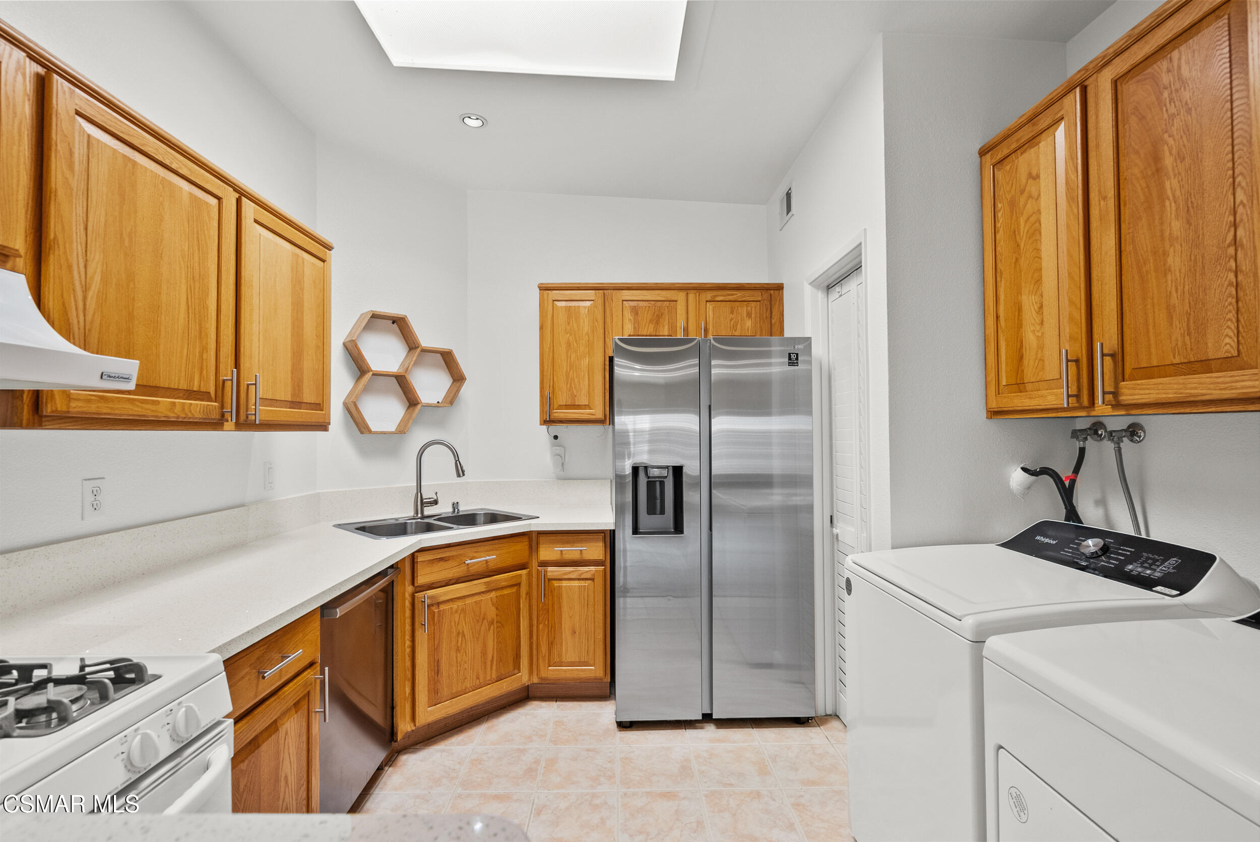 2930 Isle Way, Unit B Oxnard, CA 93035 - Photo 15 of 35 a kitchen with stainless steel appliances granite countertop a sink and a refrigerator