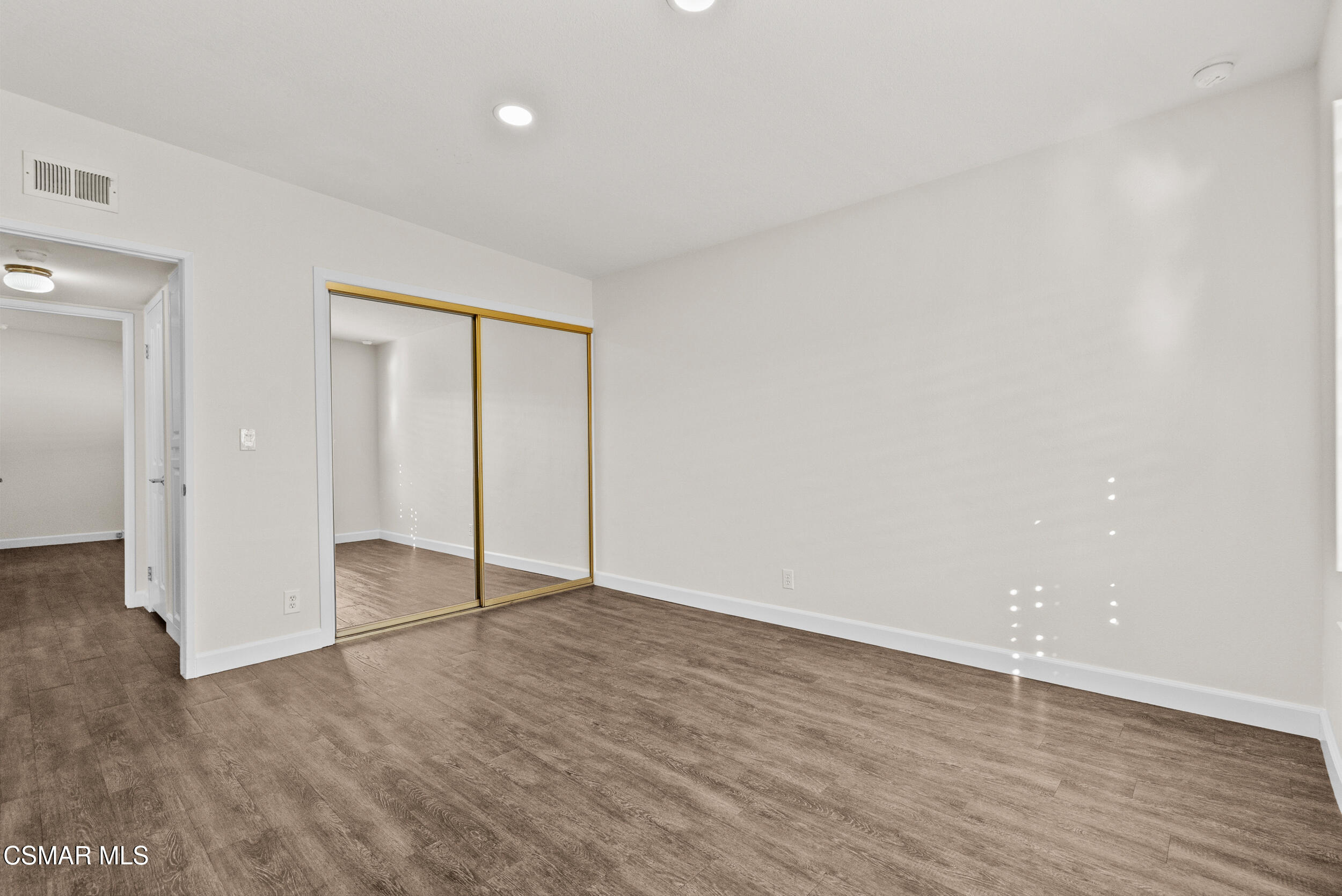 2930 Isle Way, Unit B Oxnard, CA 93035 - Photo 19 of 35 a view of an empty room with wooden floor