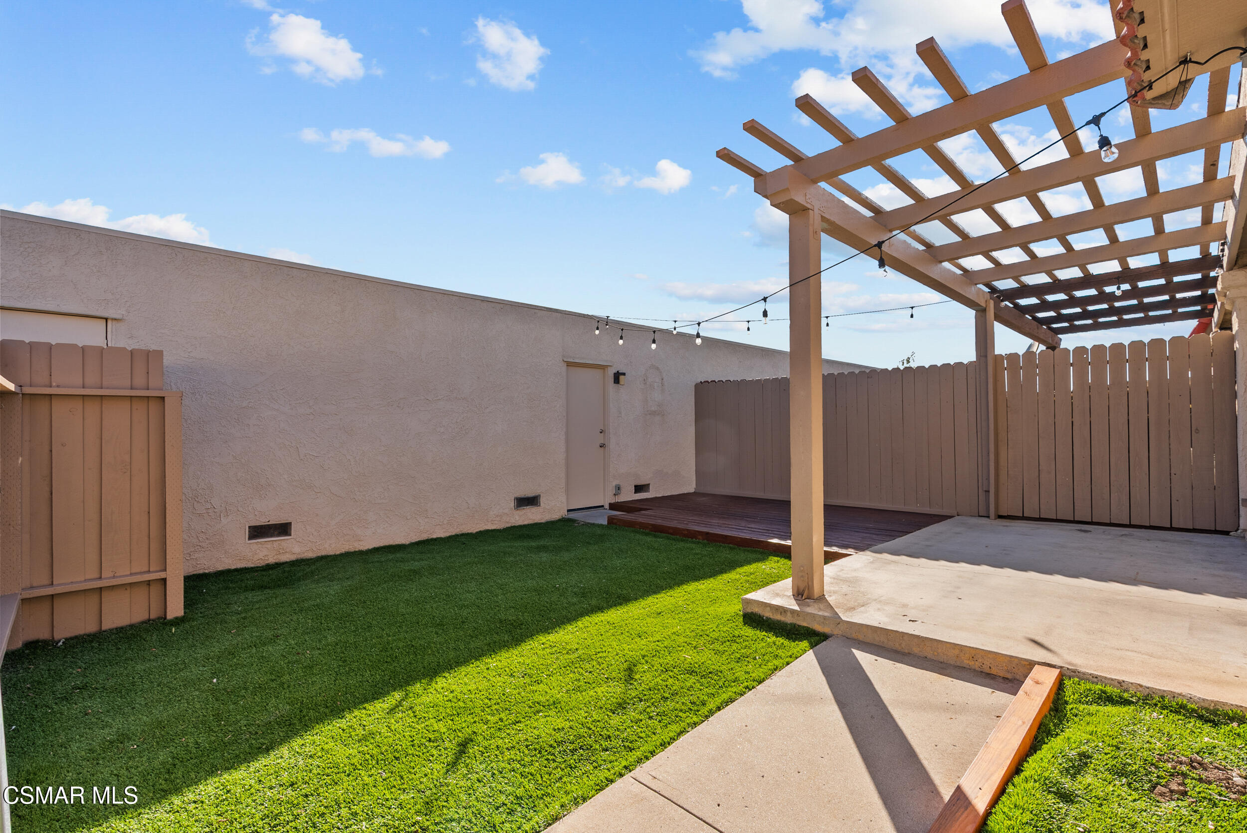2930 Isle Way, Unit B Oxnard, CA 93035 - Photo 5 of 35 a backyard of a house with plants and wooden fence