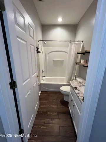 a view of living room with furniture and wooden floor