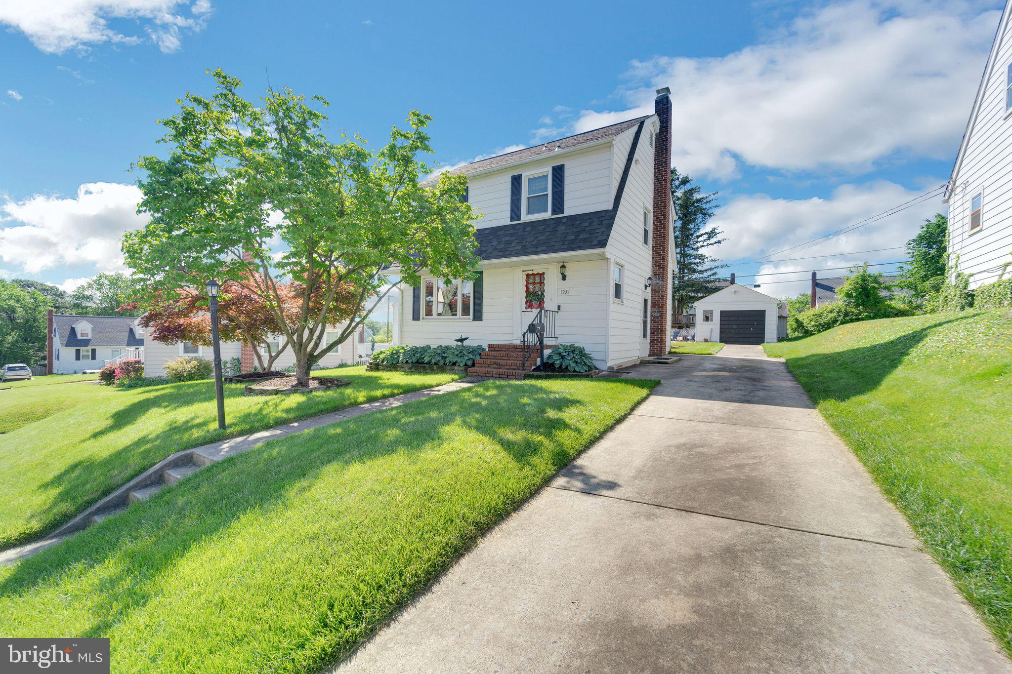 1251 Oakland Terrace Road Halethorpe, MD 21227 - Photo 1 of 34 a front view of a house with a yard and trees