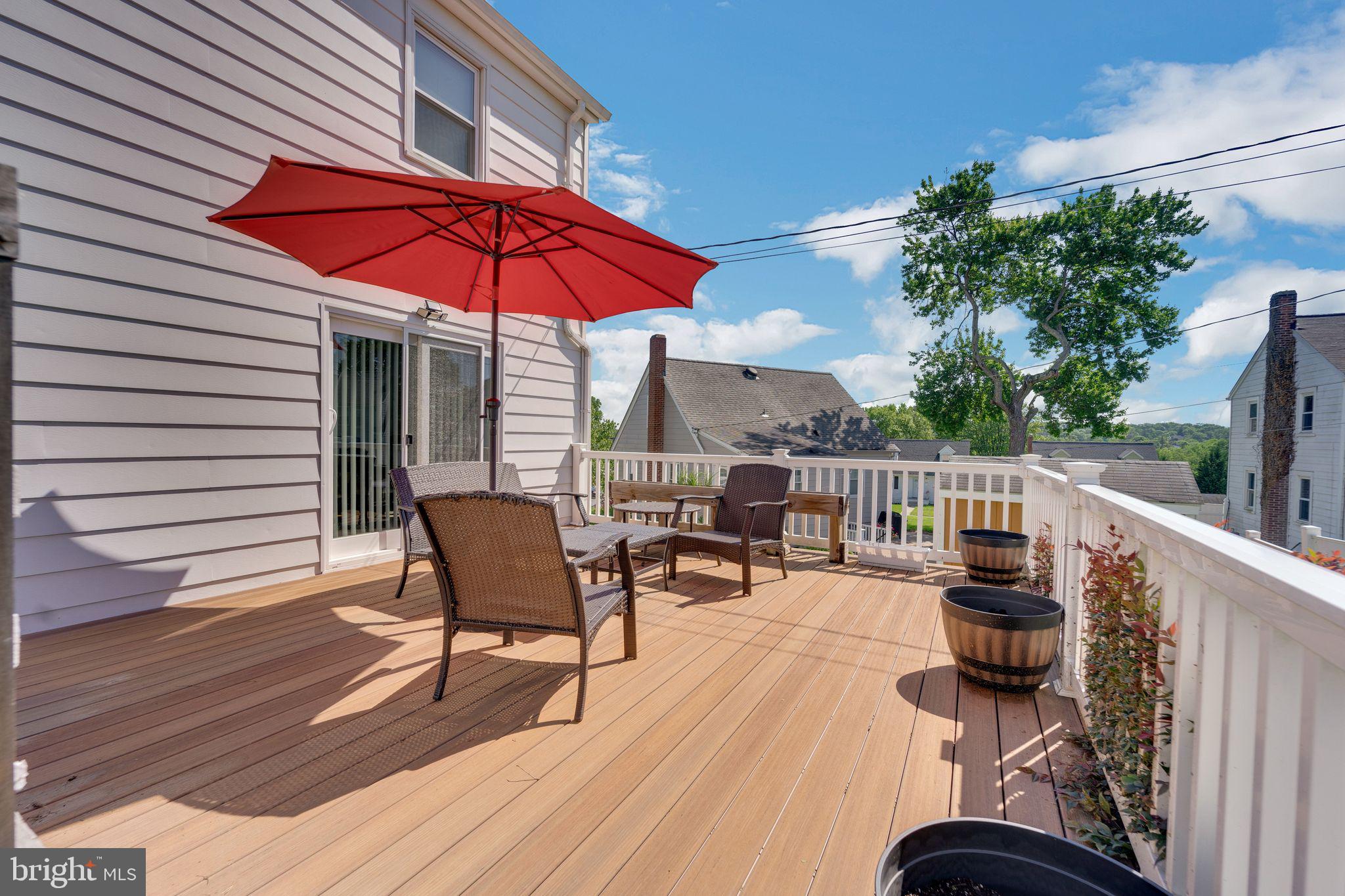 1251 Oakland Terrace Road Halethorpe, MD 21227 - Photo 23 of 34 a balcony with wooden floor table and chairs