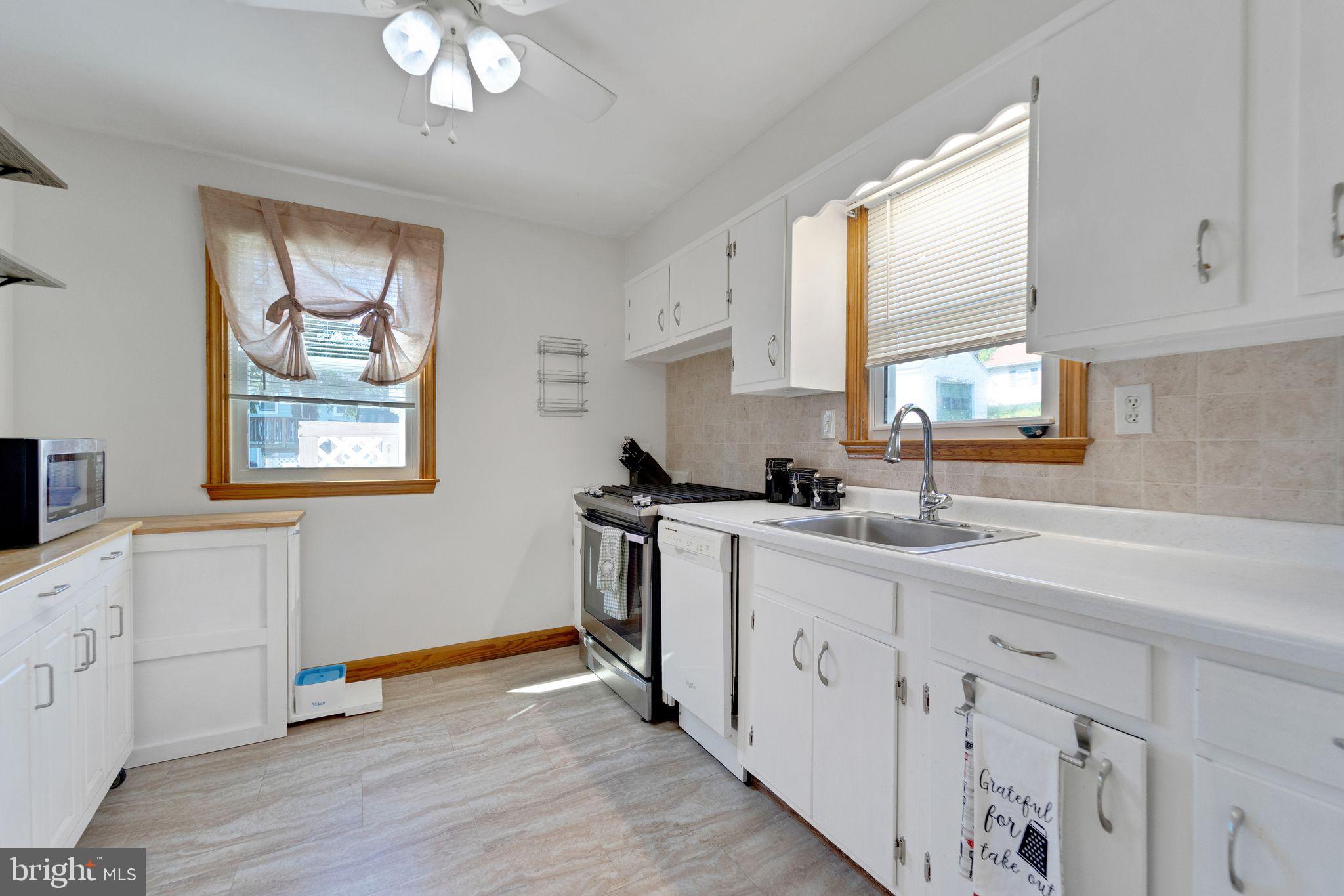 1251 Oakland Terrace Road Halethorpe, MD 21227 - Photo 8 of 34 a kitchen with appliances cabinets and a window