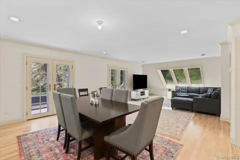 a living room with furniture kitchen and a large window