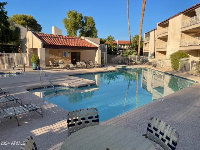 a view of a swimming pool with outdoor seating