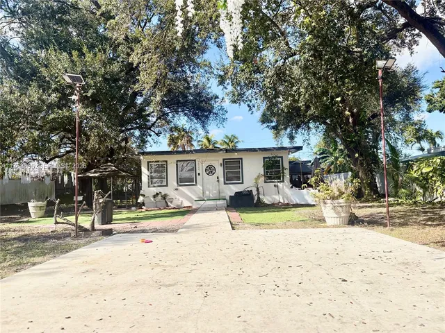 a view of a house with snow on the road