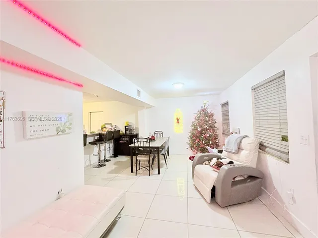 a living room with furniture and a dining space