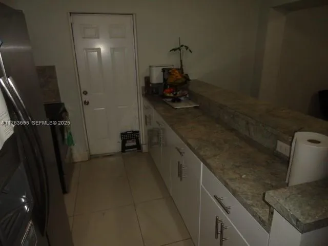 a bathroom with a granite countertop sink a toilet and shower