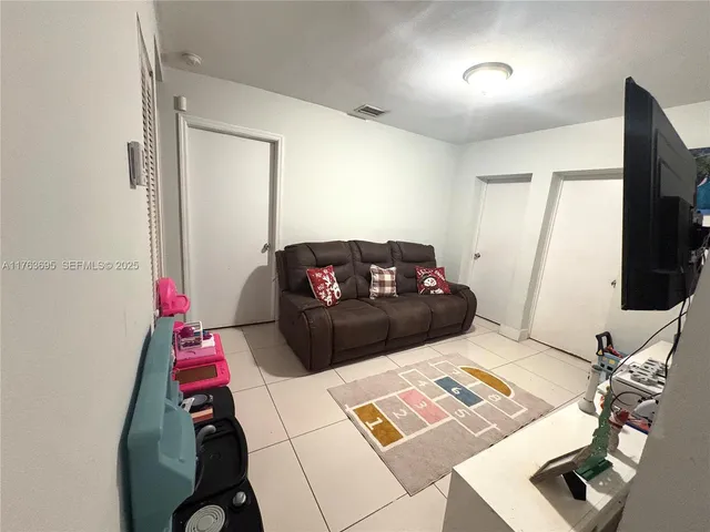 a living room with a couch and a flat screen tv